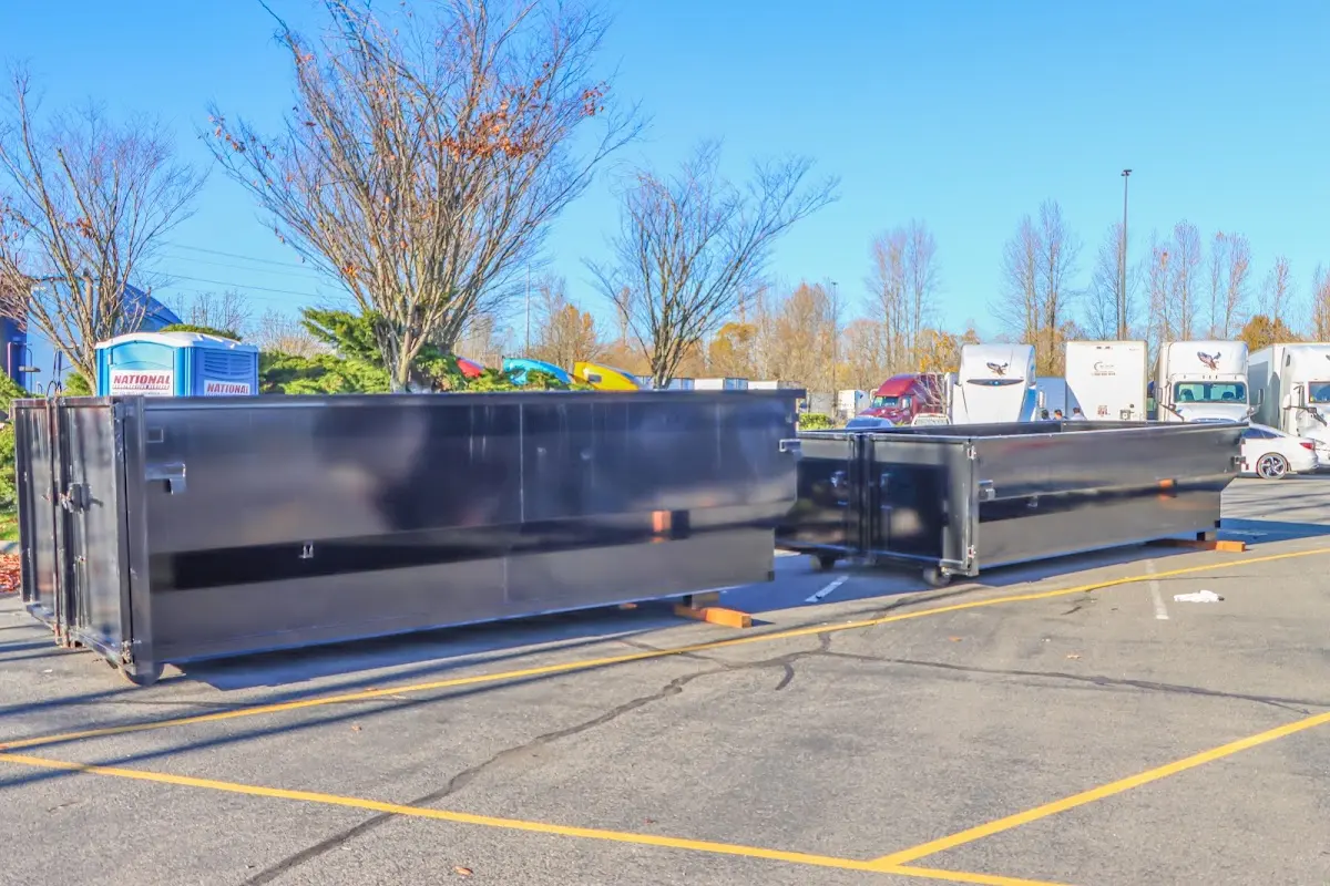 Professional dumpster rental service with roll-off container on residential driveway in Three Rivers